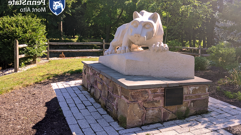 Sunny photo of shrine with Penn State Mont Alto logo